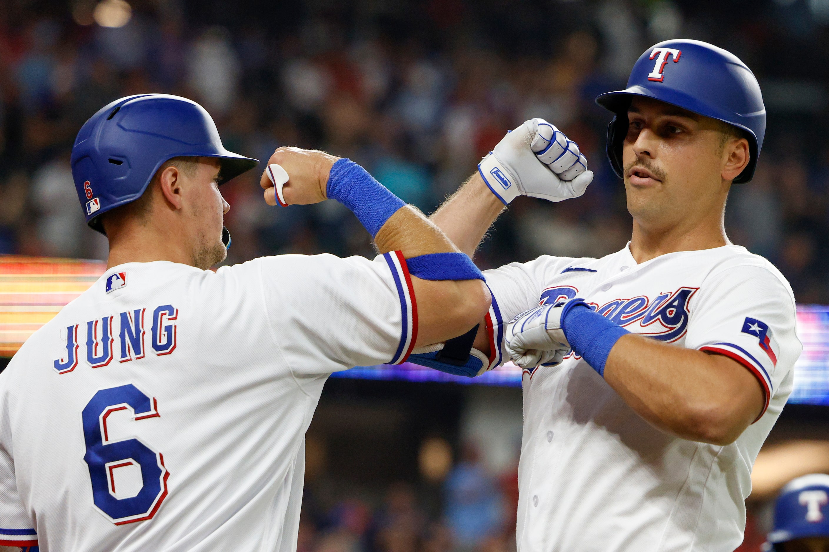 Texas Rangers first baseman Nathaniel Lowe (30) celebrates his two run home run with third...