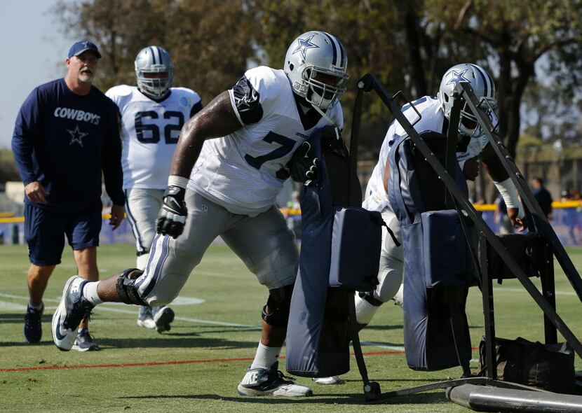 Dallas Cowboys offensive tackle Chaz Green (79) pushes the blocking sled during afternoon...