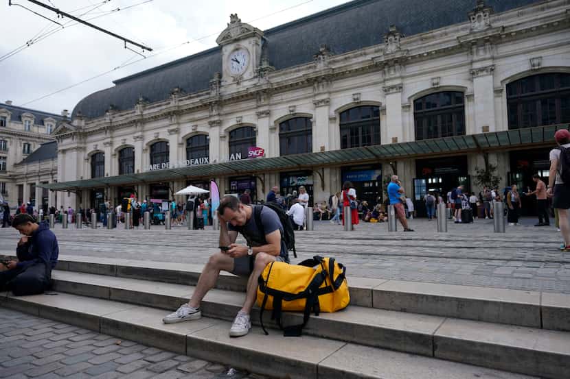 Travelers wait outside the Gare de Bordeaux Saint-Jean at the 2024 Summer Olympics, Friday,...