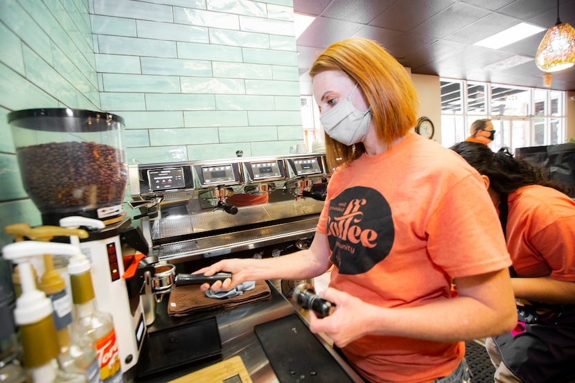 Natasha Weir grinds fresh coffee beans to prepare a cup of coffee for a customer at Well...