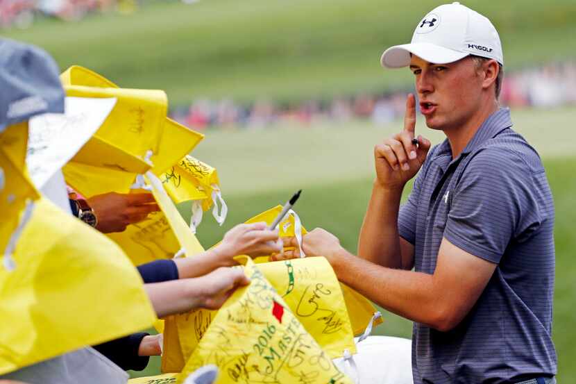 Jordan Spieth tries to quiet autograph seekers during the par three competition at the...