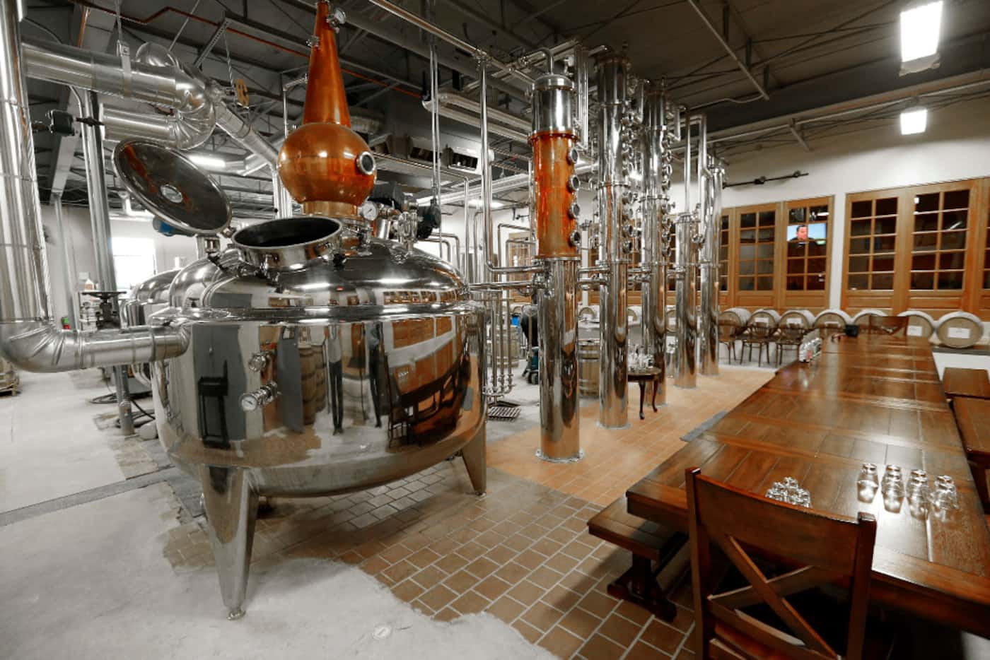 A tasting table is set up in the distillery for groups wanting to visit and experience Acre...