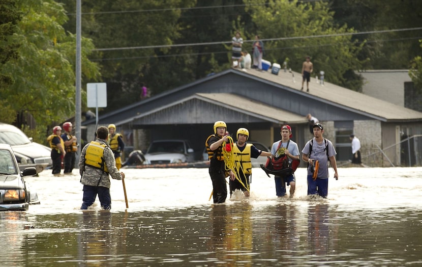 Tyler Pinnell, second from right, and his roommate Taylor McIntyre, wlak through the...