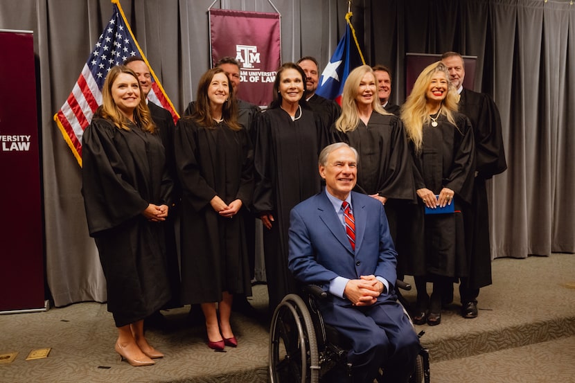 Texas Governor Greg Abbott poses for a photograph with newly appointed judges of the Texas...