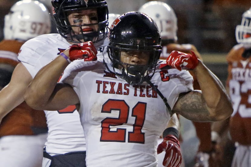 Texas Tech's DeAndre Washington (21) celebrates his touchdown during the second half of an...
