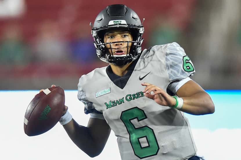 North Texas sophomore quarterback Mason Fine (6) looks for an open teammate, while being...