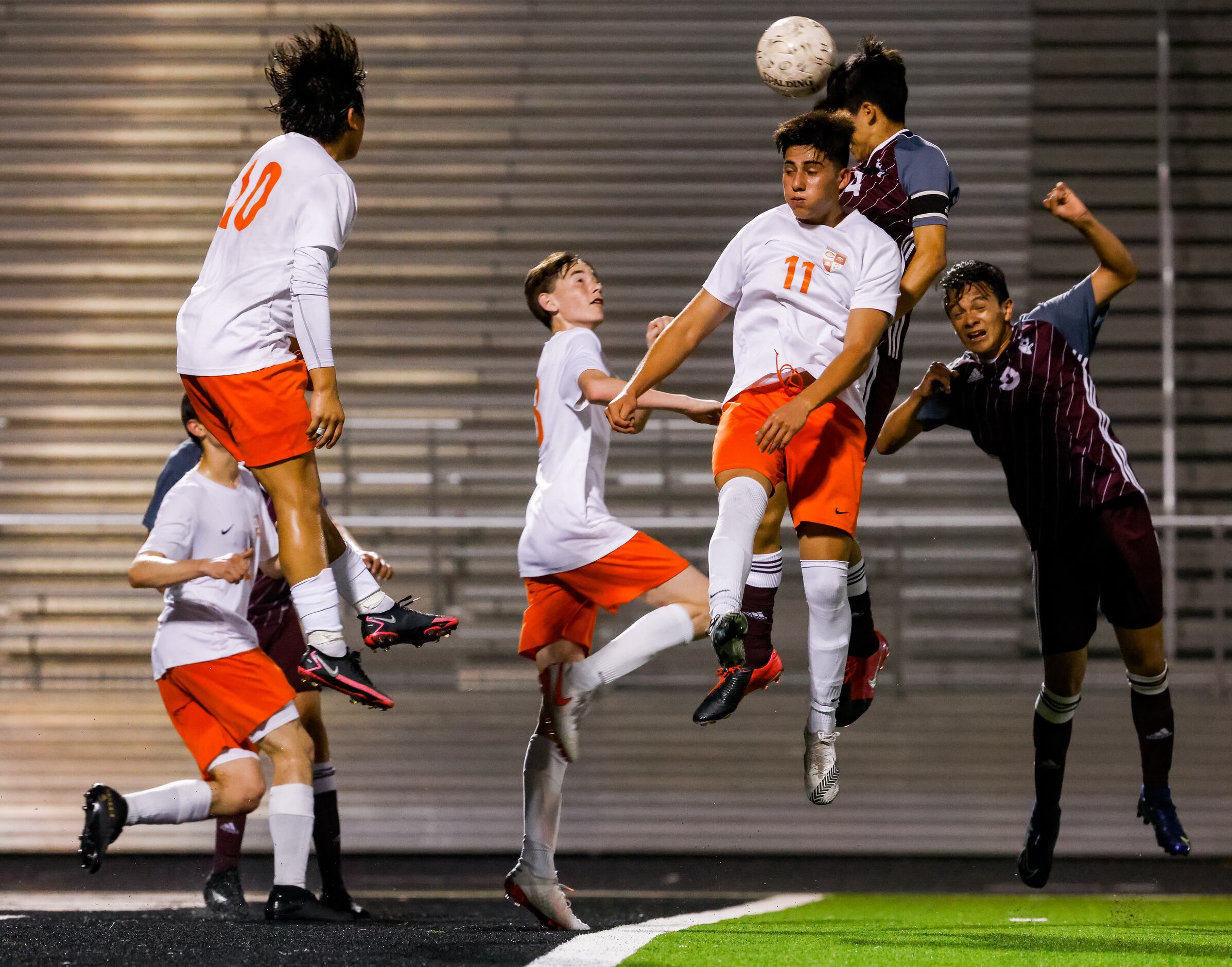 Celina and Palestine players jump for the ball during the first half of a boys soccer Class...