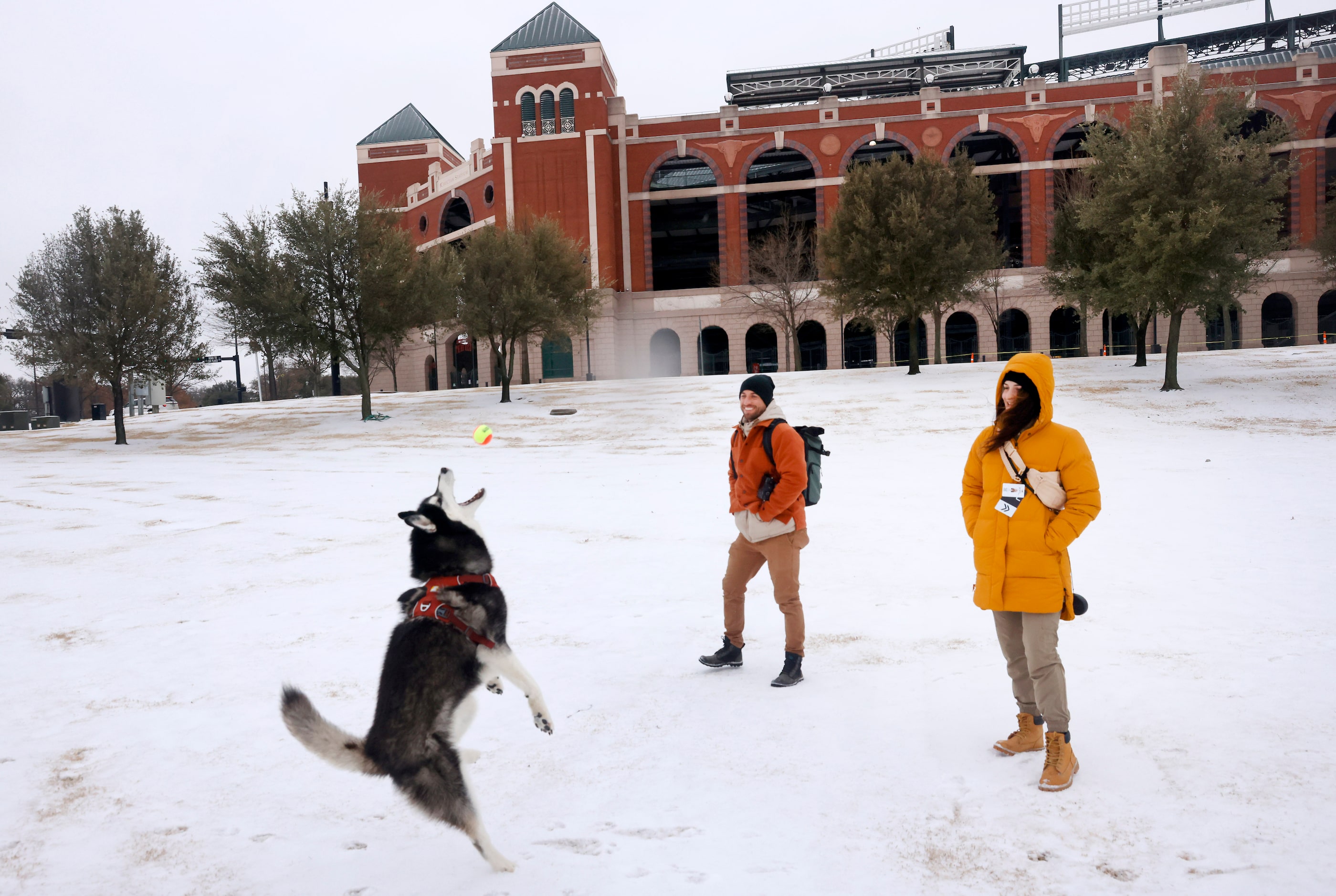 After a band of sleet dropped about 2 inches of sleet in Arlington, Eve Godat (right) and...