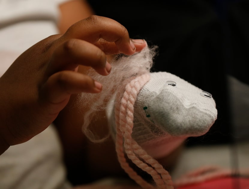 As part of At Last's Tuesday night creative writing lesson, students created sock puppets to...