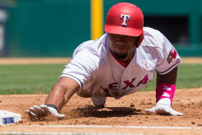 Texas Rangers shortstop Elvis Andrus (1) makes it back to first base during the first inning...