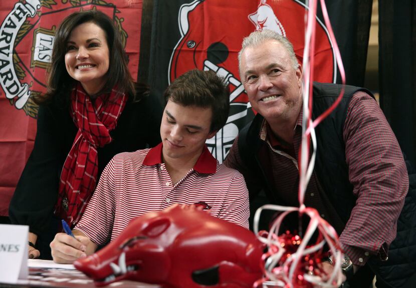Stephen and Karen Jones pose for a photograph with their son, Highland Park quarterback John...