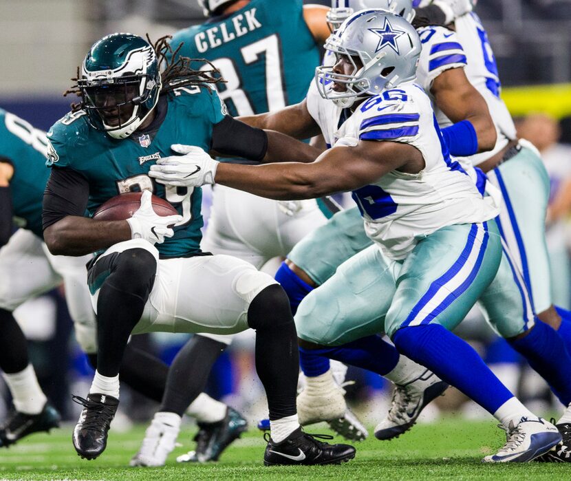 Dallas Cowboys defensive end Lewis Neal (66) tackles Philadelphia Eagles running back...