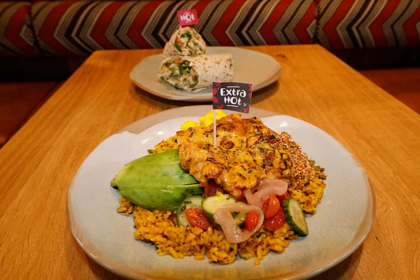 The PERi Chicken Rainbow Bowl, foreground, and the Sweet & Spicy Chicken Wrap are two of the...