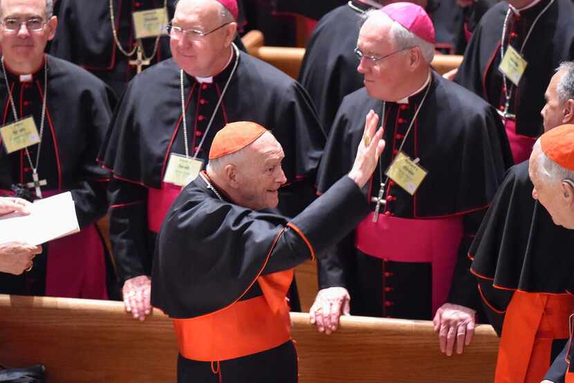 Cardinal Theodore McCarrick waves to fellow bishops at the Cathedral of St. Matthew the...