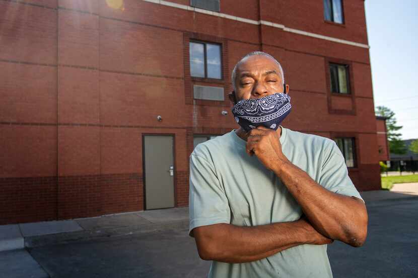 Terry Thompson poses for a portrait outside the extended-stay hotel where he lives with his...