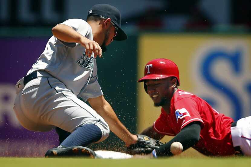 Texas Rangers designated hitter Jurickson Profar (19) slides into second base as Seattle...