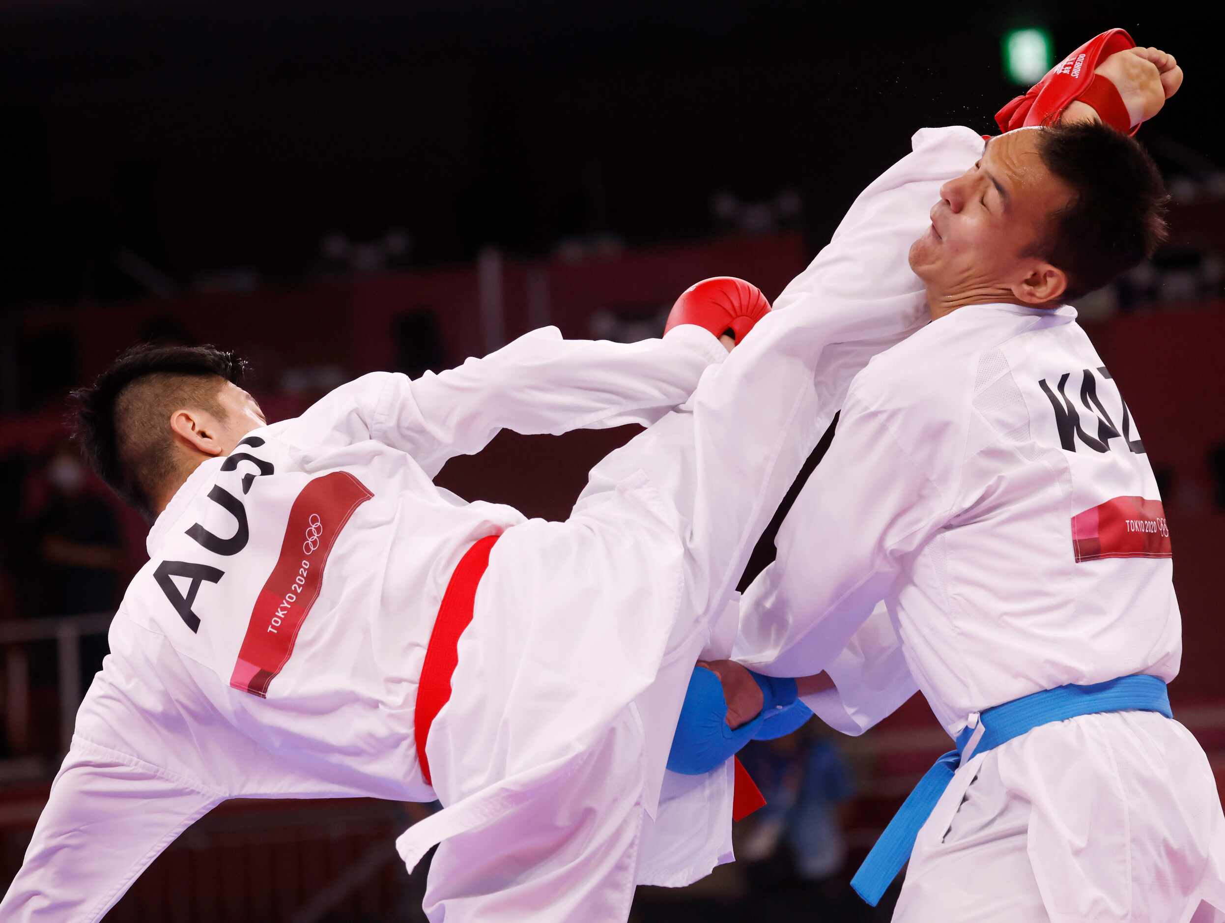 Australia’s Tsuneari Yahiro attempts to kick Kazakhstan’s Nurkanat Azhikanov in his head...