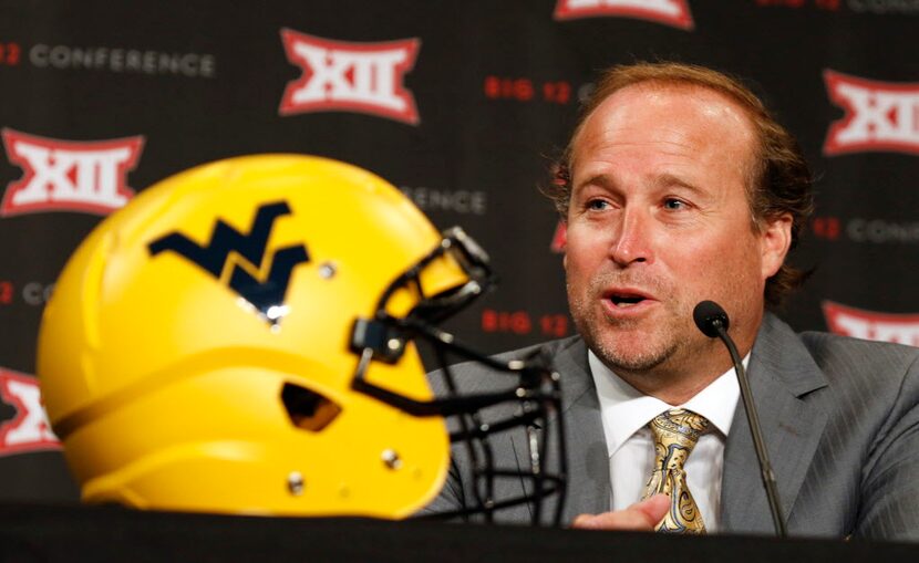 West Virginia head football coach Dana Holgorsen answers questions from the news media...