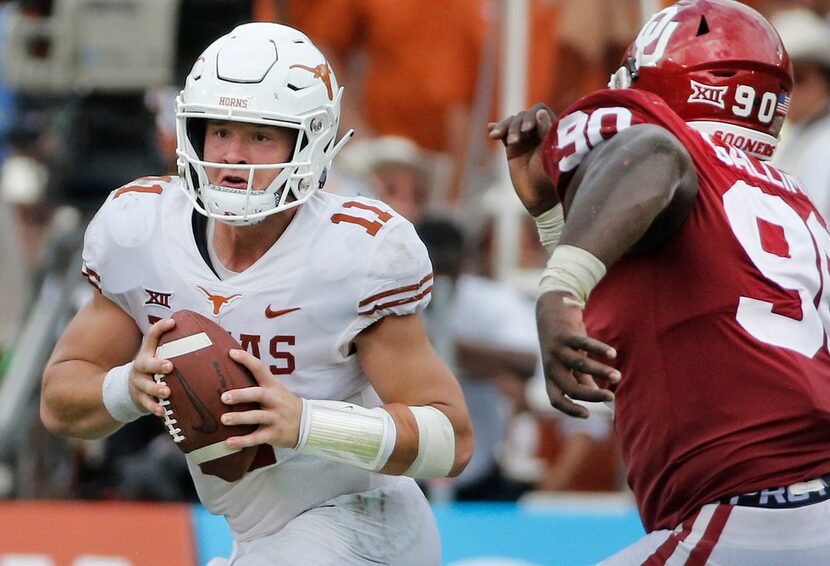 Texas Longhorns quarterback Sam Ehlinger (11) scrambles away from Oklahoma Sooners defensive...