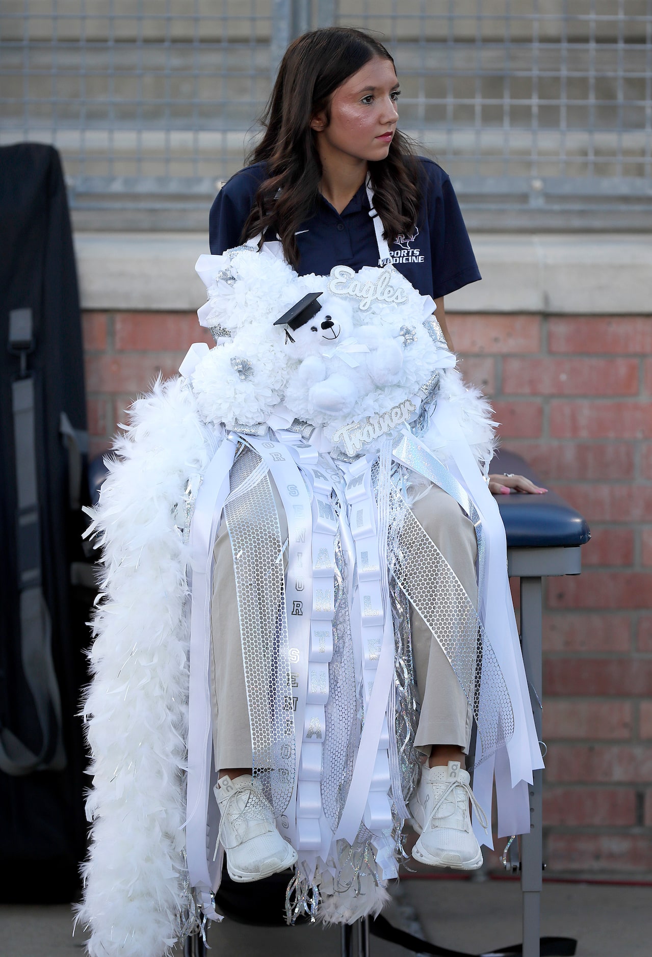 Samantha Stewart, one of the head student athletic trainers for Allen High School, wears her...