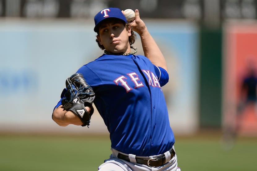 OAKLAND, CA - AUGUST 04:  Derek Holland #45 of the Texas Rangers pitches against the Oakland...