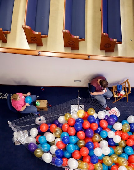 Pam Symank of Texas Balloon Arches and one of her workers, Brent Turner, blow up thousands...