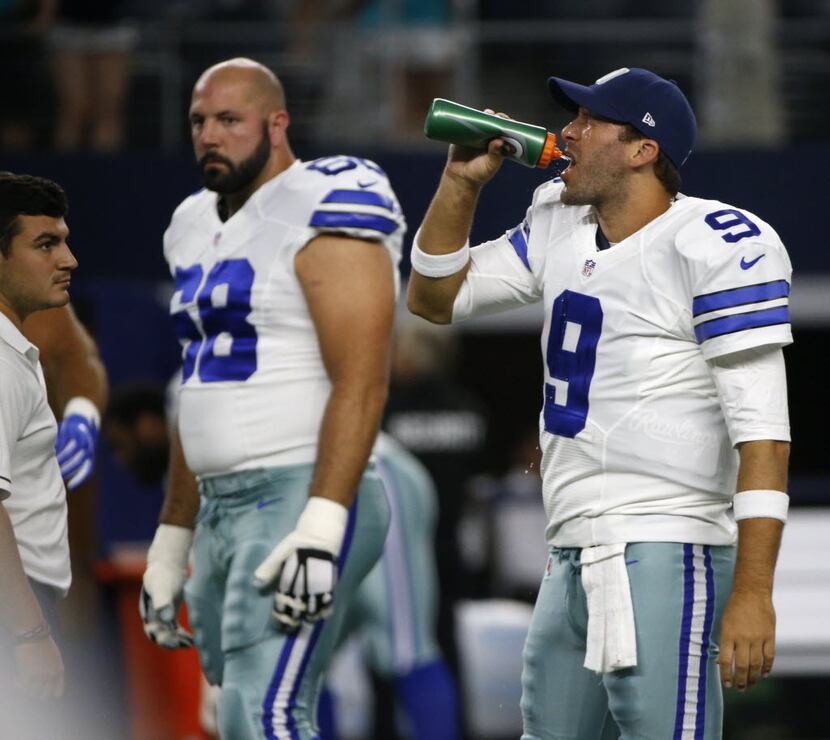 Dallas Cowboys quarterback Tony Romo (9) drinks before their game with the  Miami Dolphins...