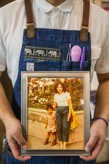 Chef Donny Sirisavath holds a photo of he and his mother Phaysane Sirisavath, who died of...