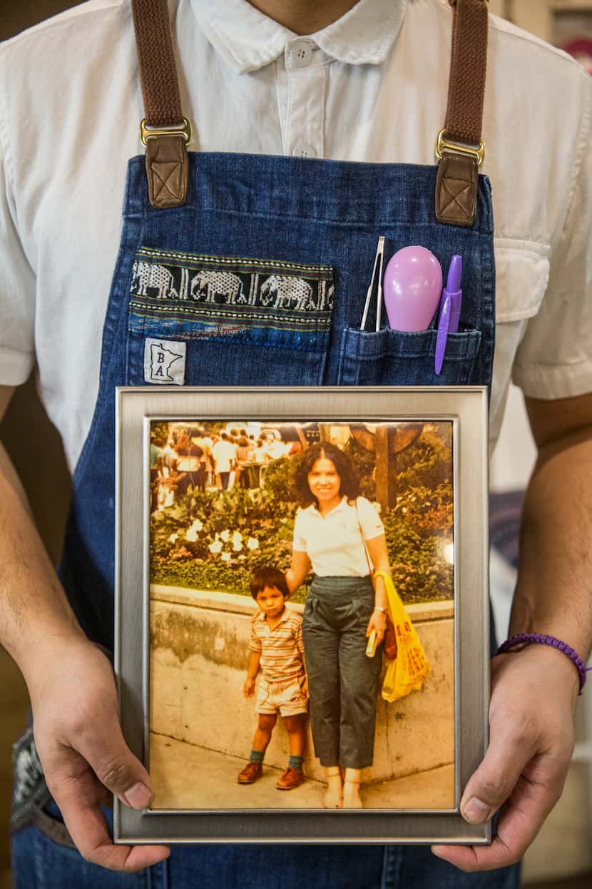 Chef Donny Sirisavath holds a photo of he and his mother, who passed away from cancer, at...