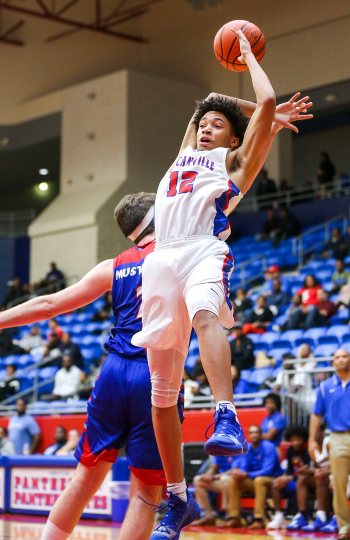 Duncanville guard Miles Bennett (12) gets fouled by J. J. Pearce forward Drew Timme (2)...