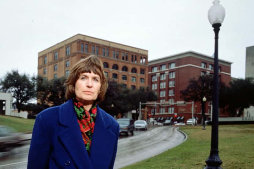 Marina Porter, standing by the grassy knoll across from the former Texas School Book...