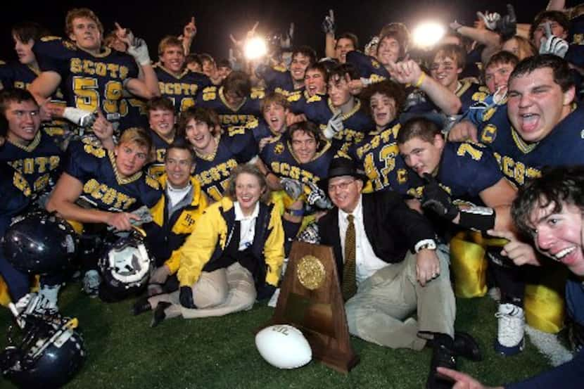 Highland Park players and staff and coach Randy Allen (center) pose with  the championship...