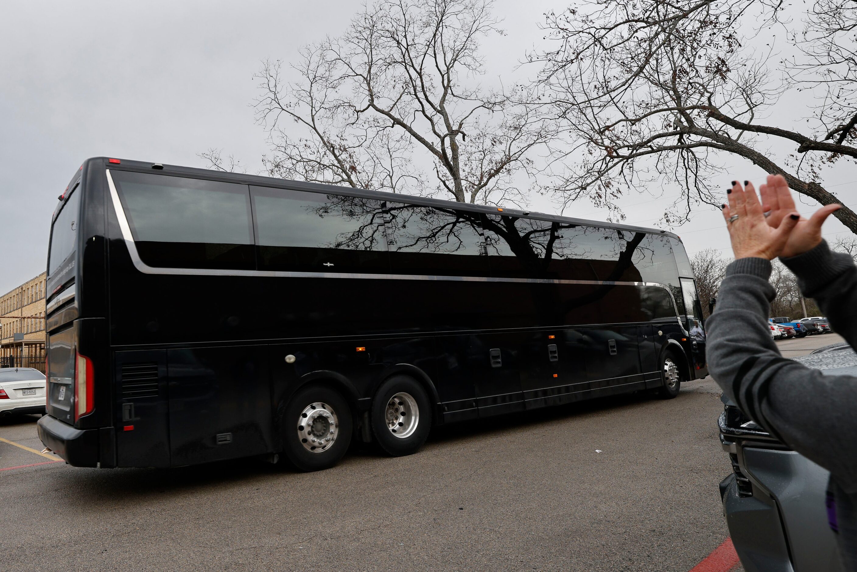 A bus, which Lincoln High School girls basketball players ride, leaves after a send-off...