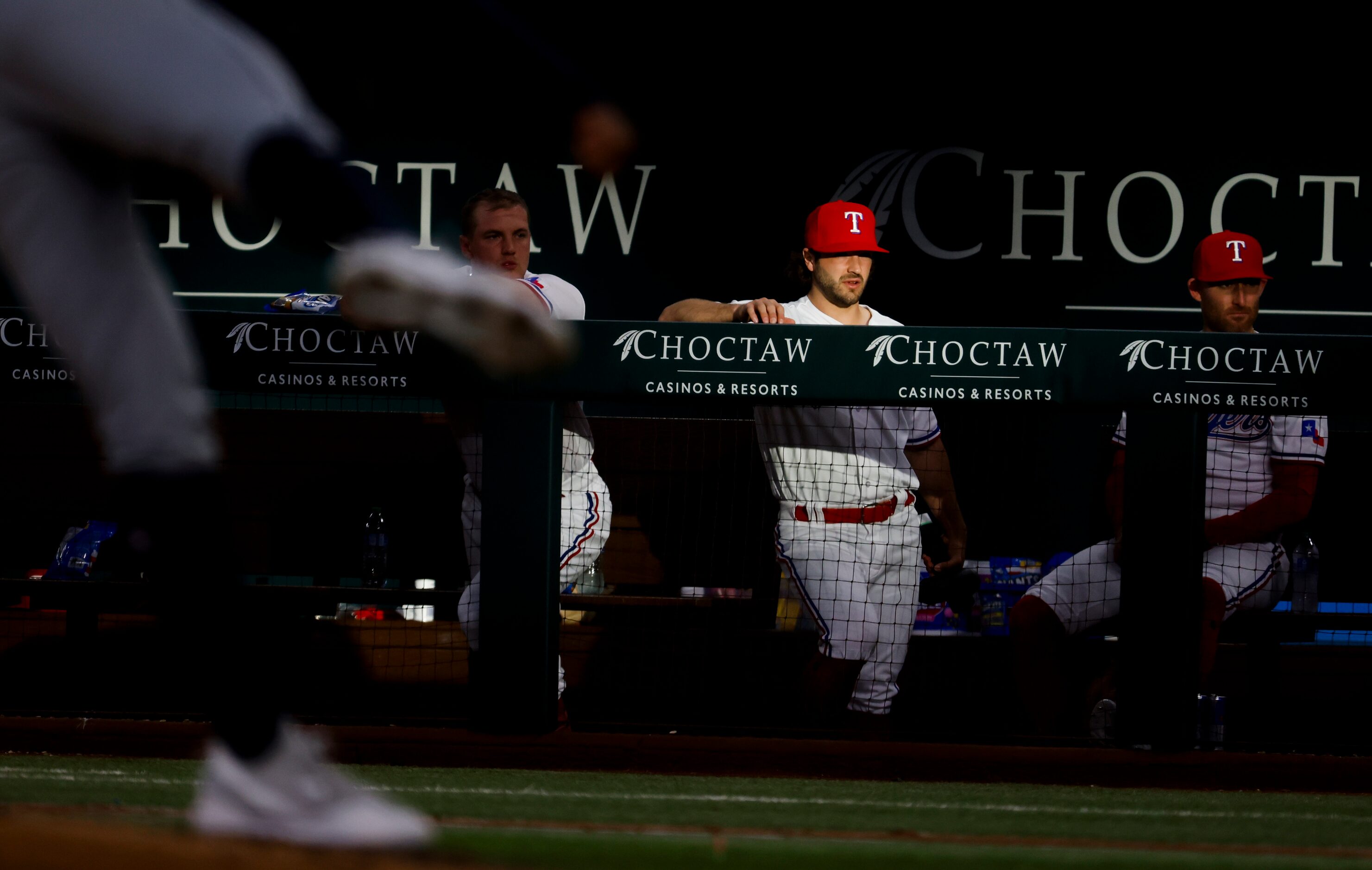 Texas Rangers shortstop Josh Smith (center) stays in the dugout during an inning break of a...