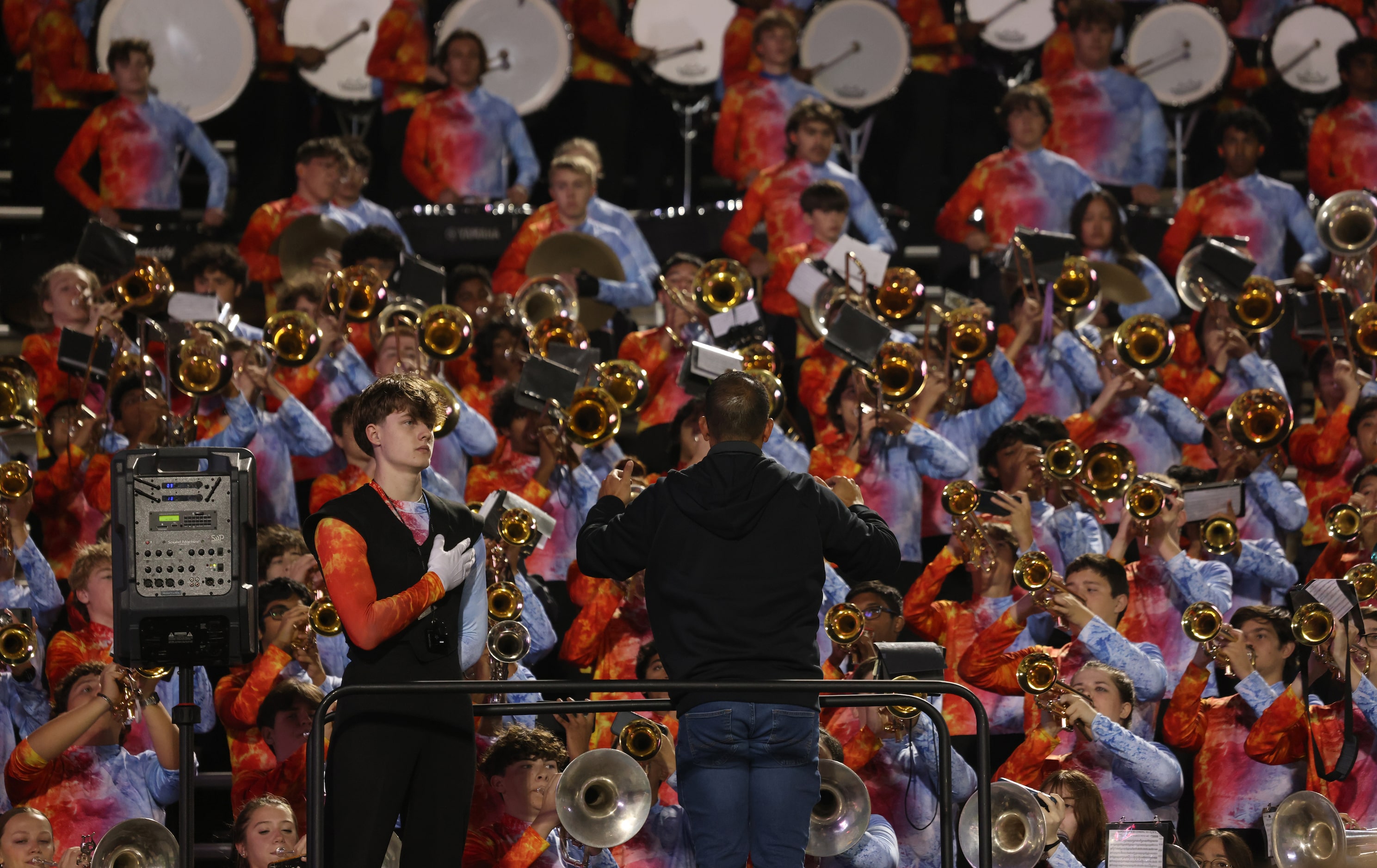 A drum major faces the presentation of the colors as Allen Eagles band members play the...