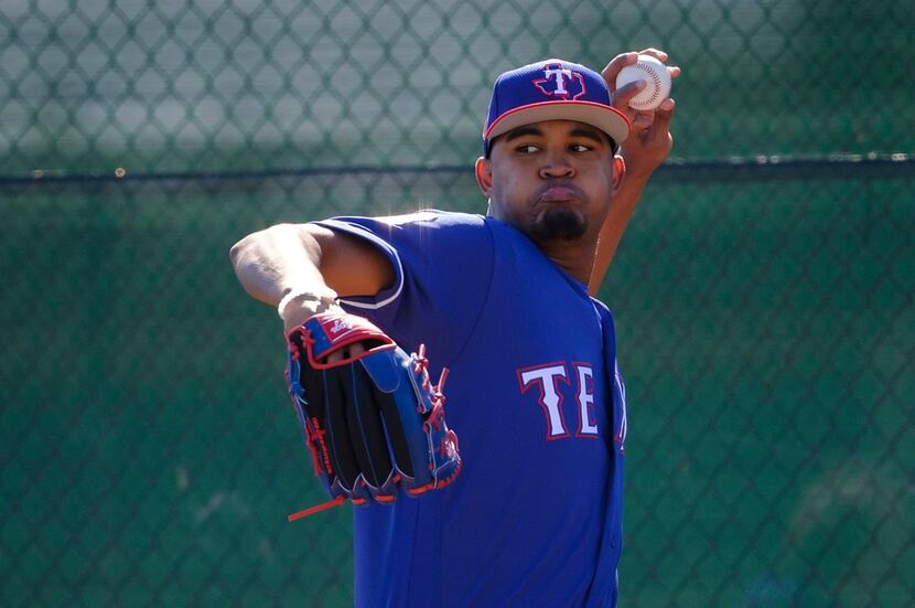 Texas Rangers pitcher Yohander Mendez throws in the bullpen during a spring training workout...