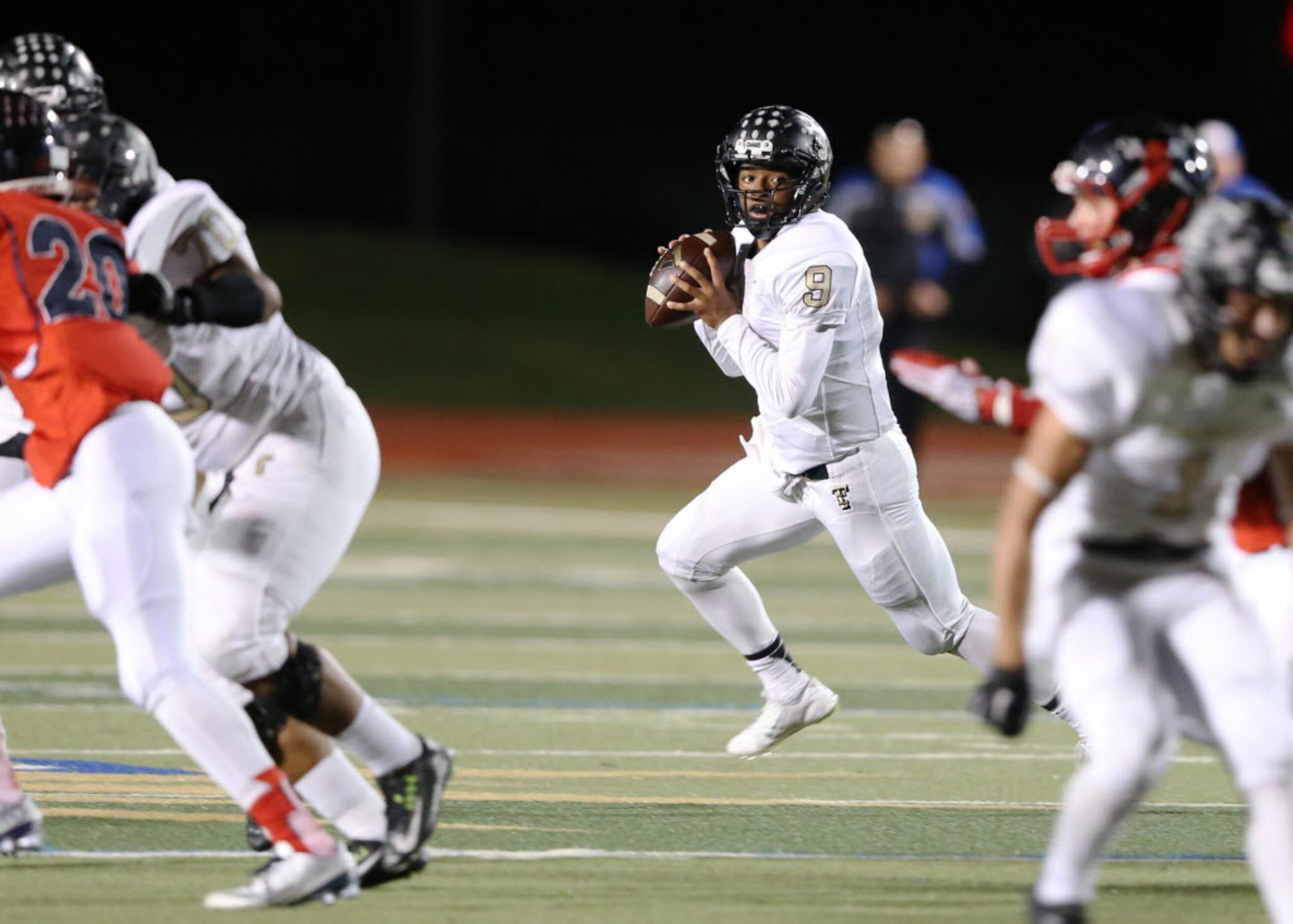 The Colony's Jemel Jones Jr. (9) scrambles out of the pocket looking to pass in a game...