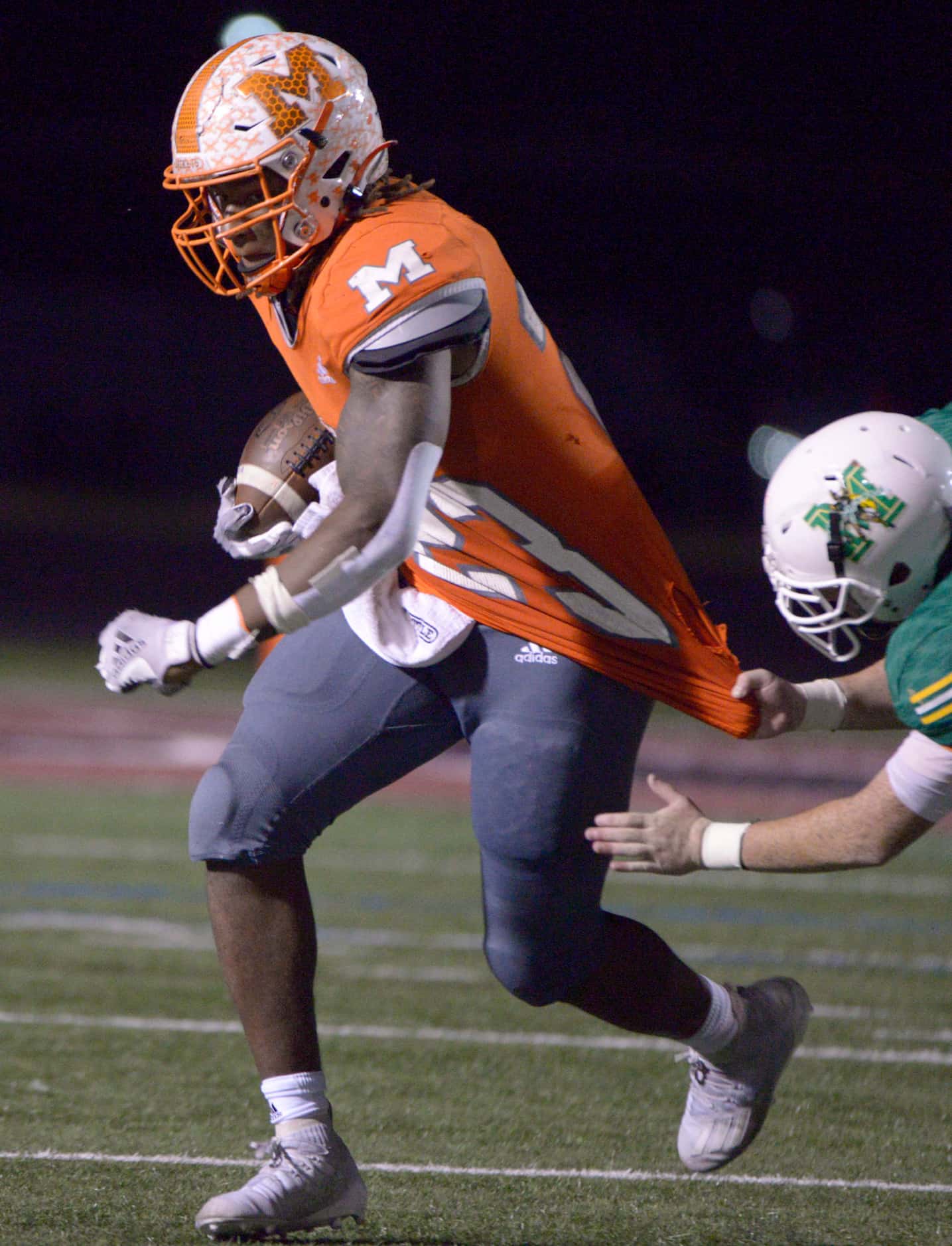 Mineola’s Trevion Sneed tries to run through a tackle attempt by Cedric Moore in the third...