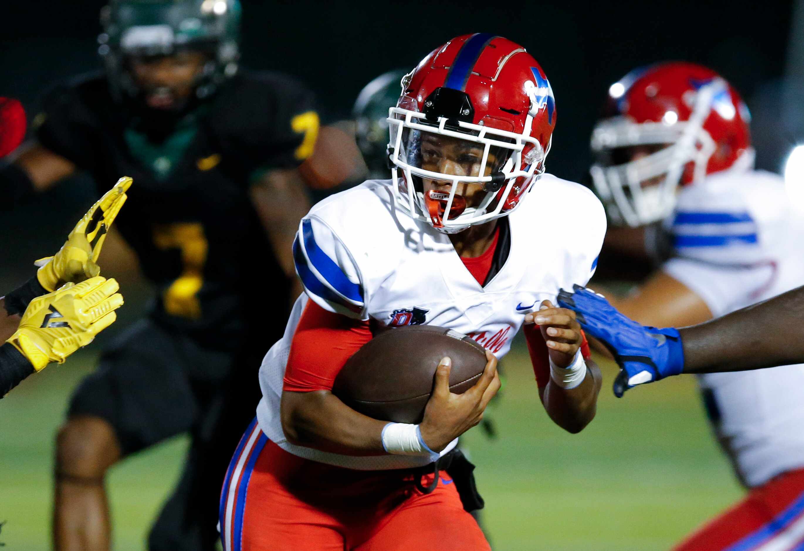 Duncanville senior quarterback Solomon James carries the ball during the second half of a...