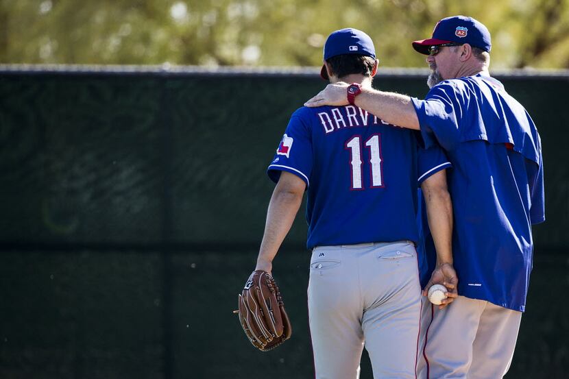 Texas Rangers pitcher Yu Darvish walks to a bullpen with pitching coach Doug Brocail  before...