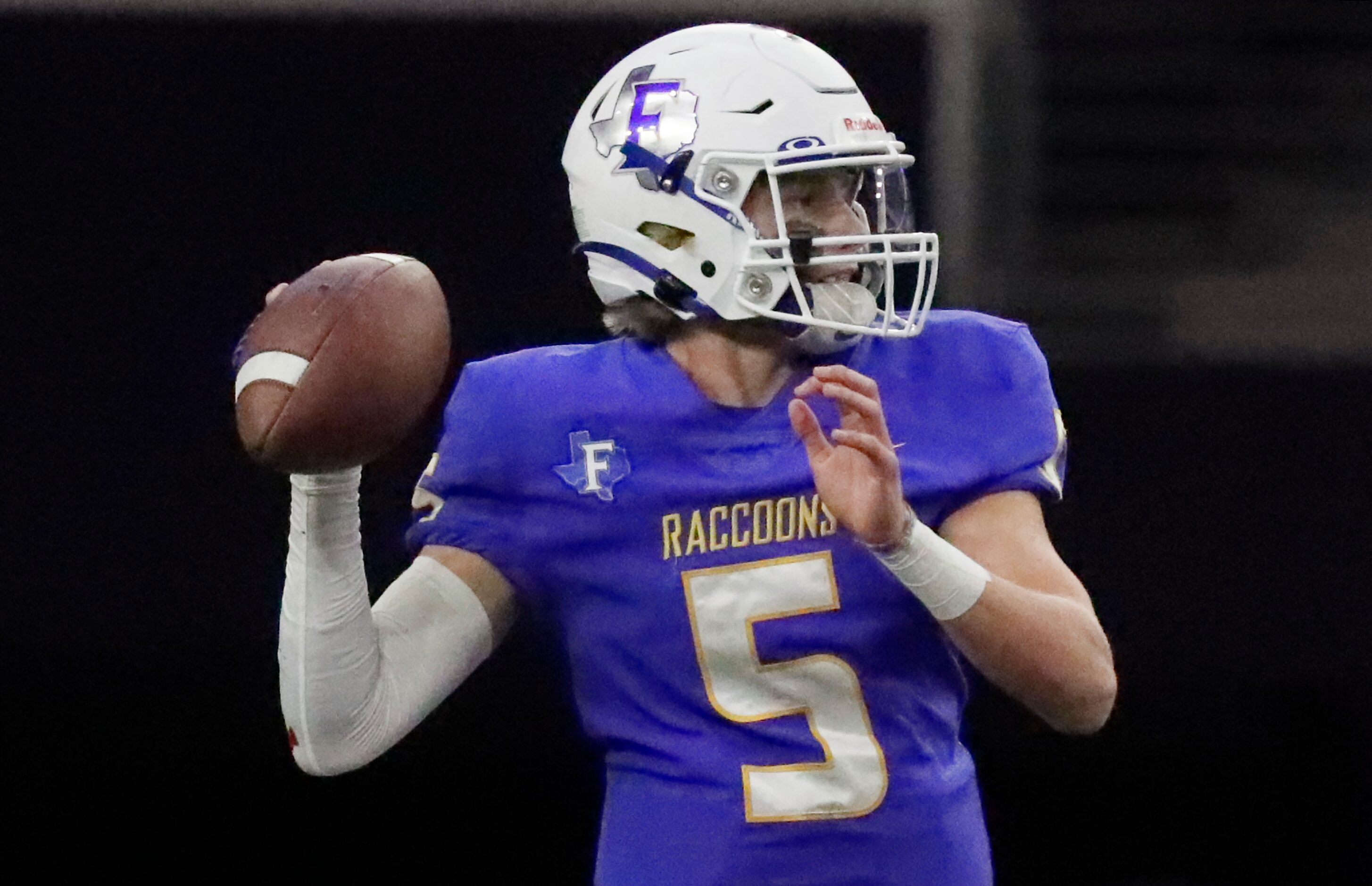 Frisco High School quarterback Cobyn Harbert (5) looks to pass during the first half as...