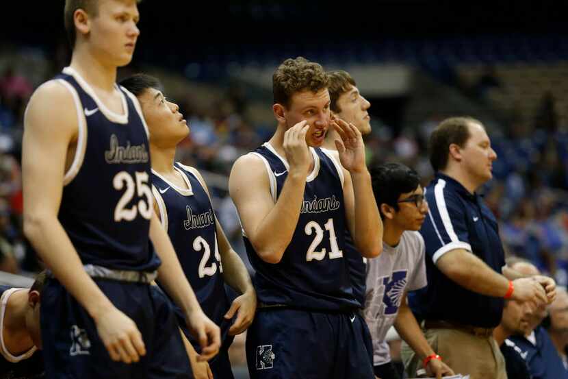 Keller's Oliver Taylor (25), Brian Shin (24) and Ben Johnson (21) react from the bench as a...