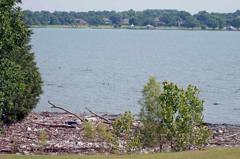 
Trash and debris covers the shoreline on Lake Ray Hubbard near Chuck and Irene Slater’s...