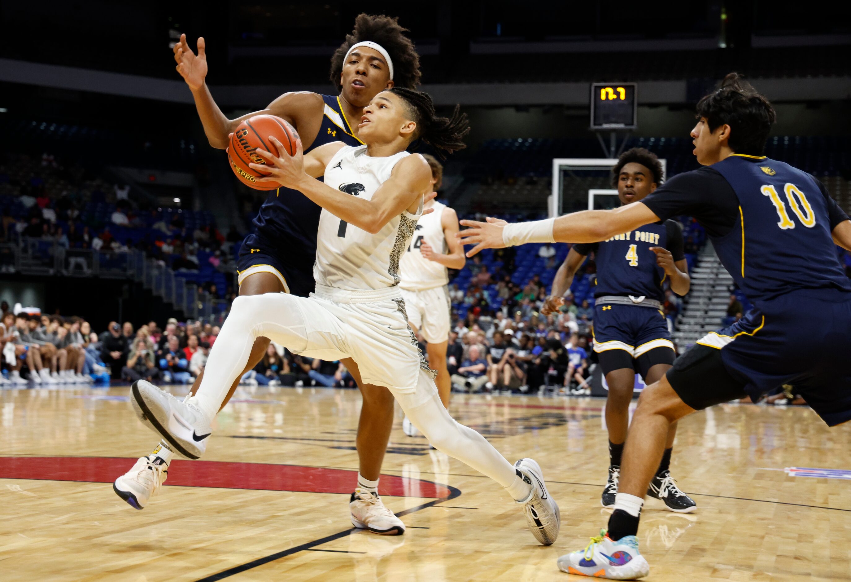 Plano East's Rachard Angton (1) drives to the basket during the UIL Class 6A boys basketball...