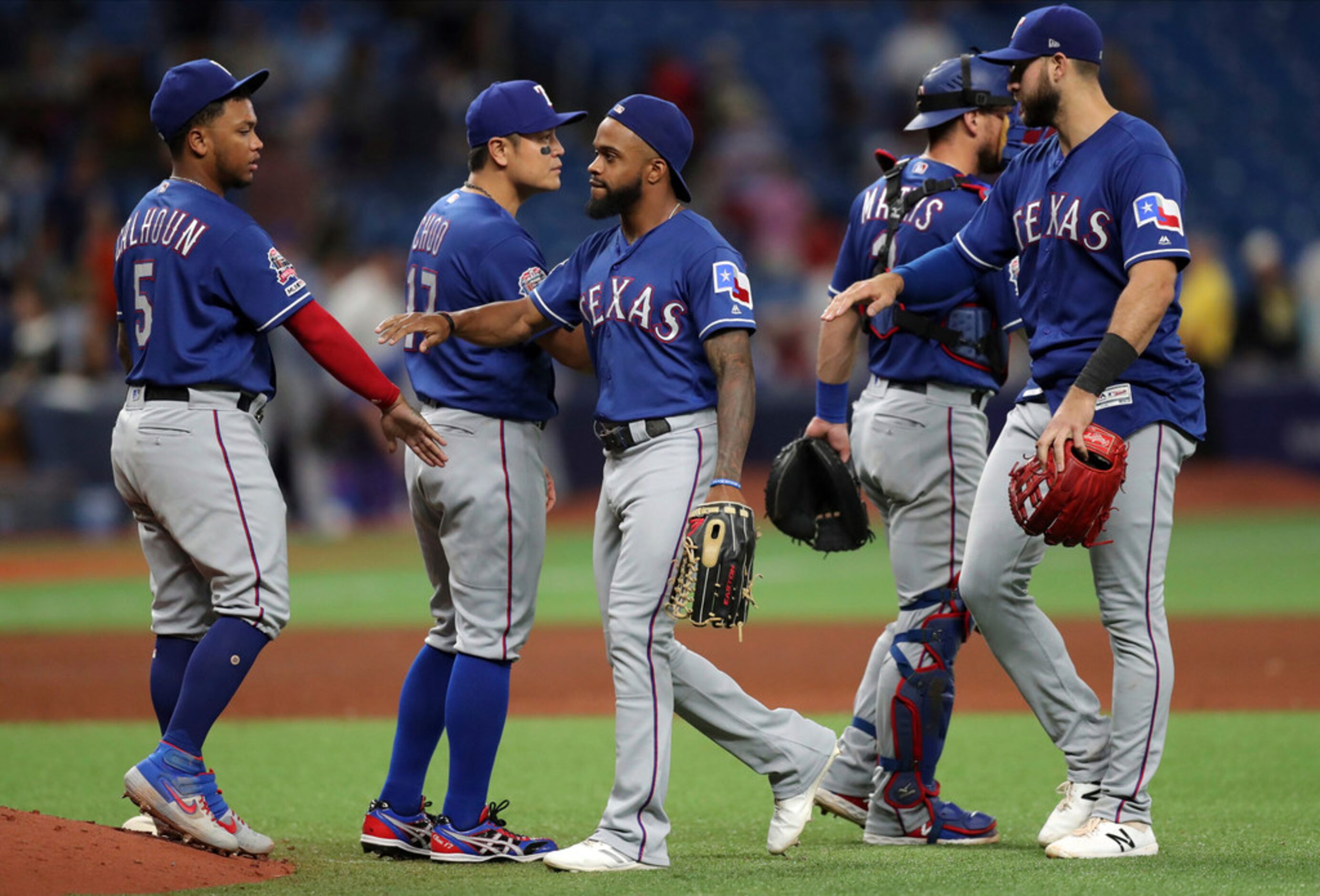 Members of the Texas Rangers celebrate a 5-0 win over the Tampa Bay Rays in a baseball game...