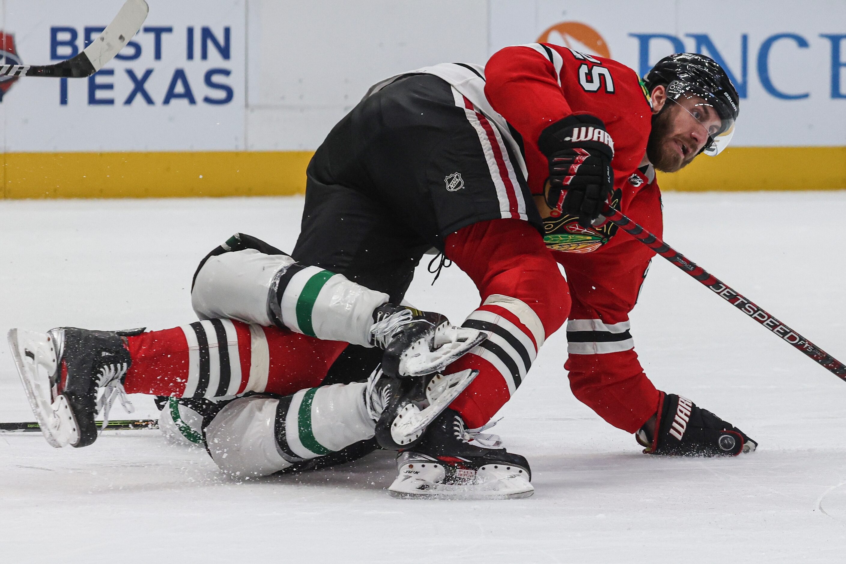 Chicago Blackhawks defenseman Jarred Tinordi (25) gets tangled in the legs of Dallas Stars...