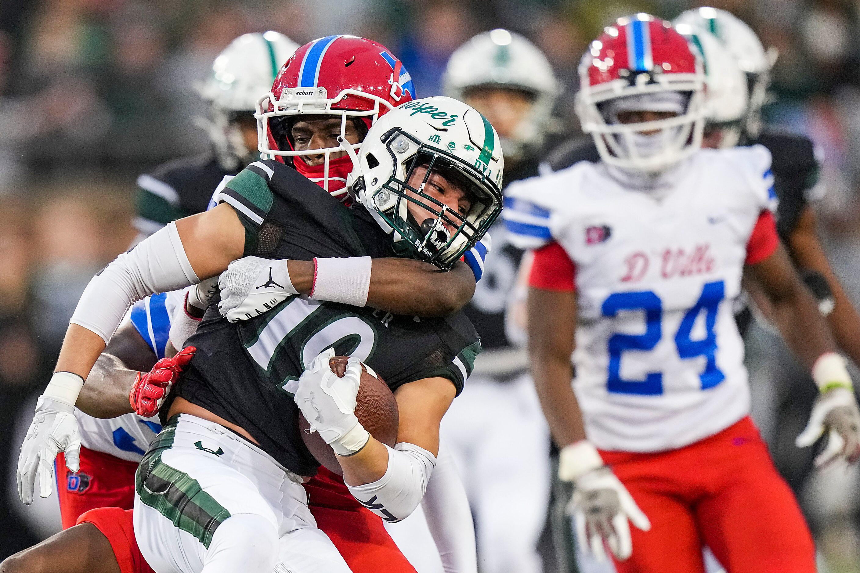 Prosper’s Bo Mongaras (19) is brought down by Duncanville’s Kalen McInnis (14) on a kick...