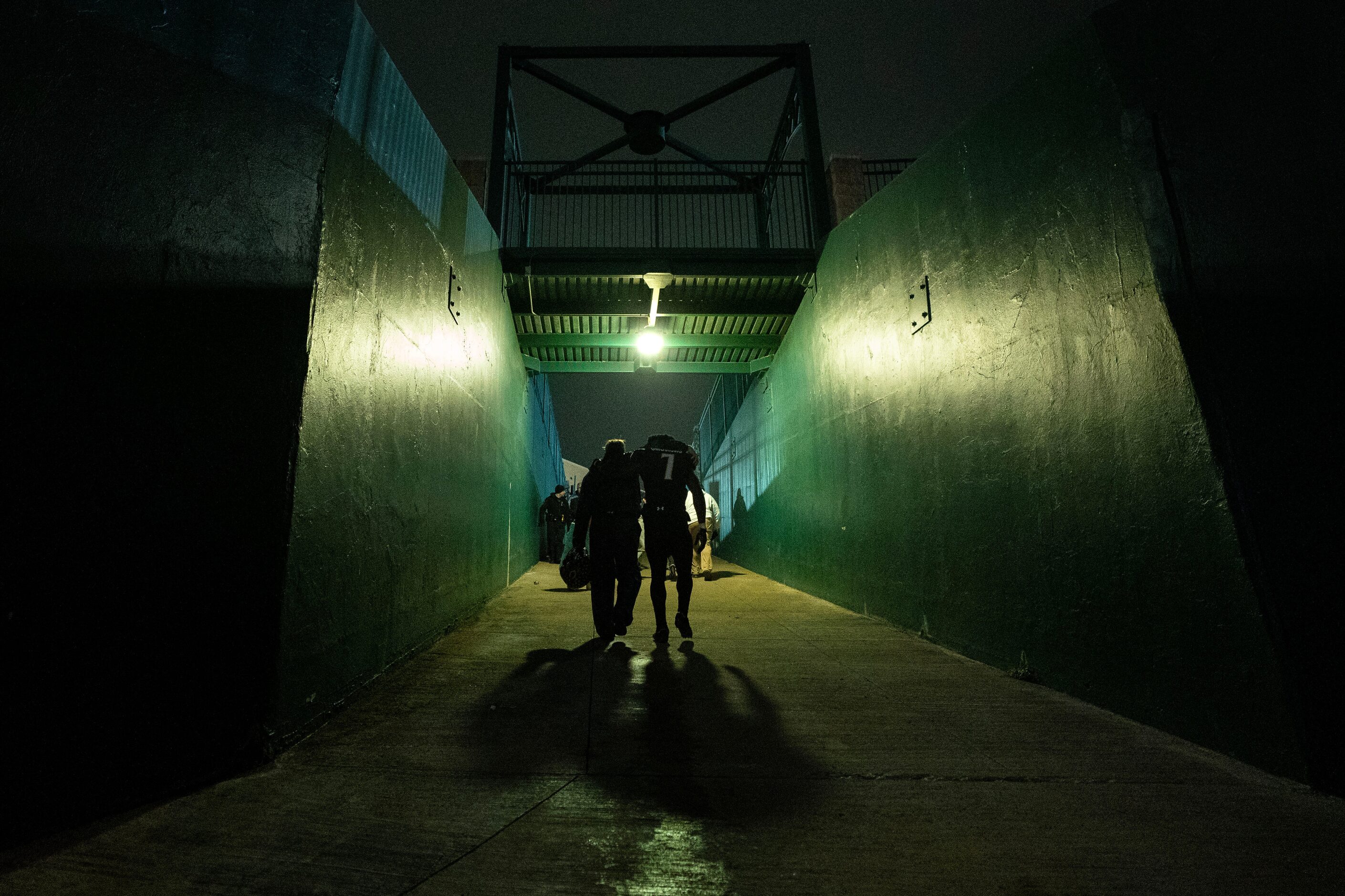 Crandall senior wide receiver Samuel Omosigho (7) walks up the tunnel with Marc Moffitt,...