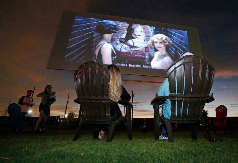 Tina and Art Lira of Lewisville settle in to watch the "Coming Attractions" reel at the...