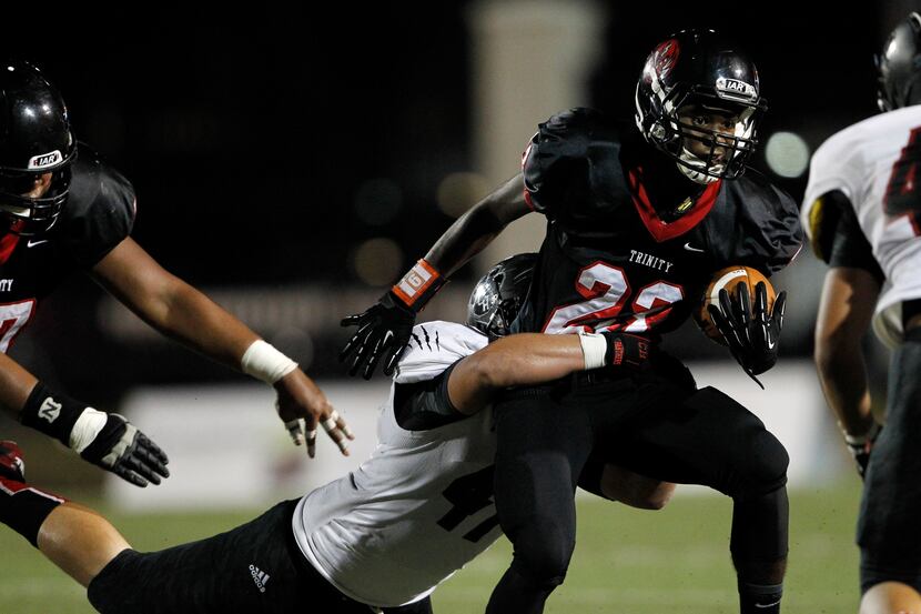 Colleyville Heritage's Braxton Martin (47) tries to take down Euless Trinity's Markis McCray...